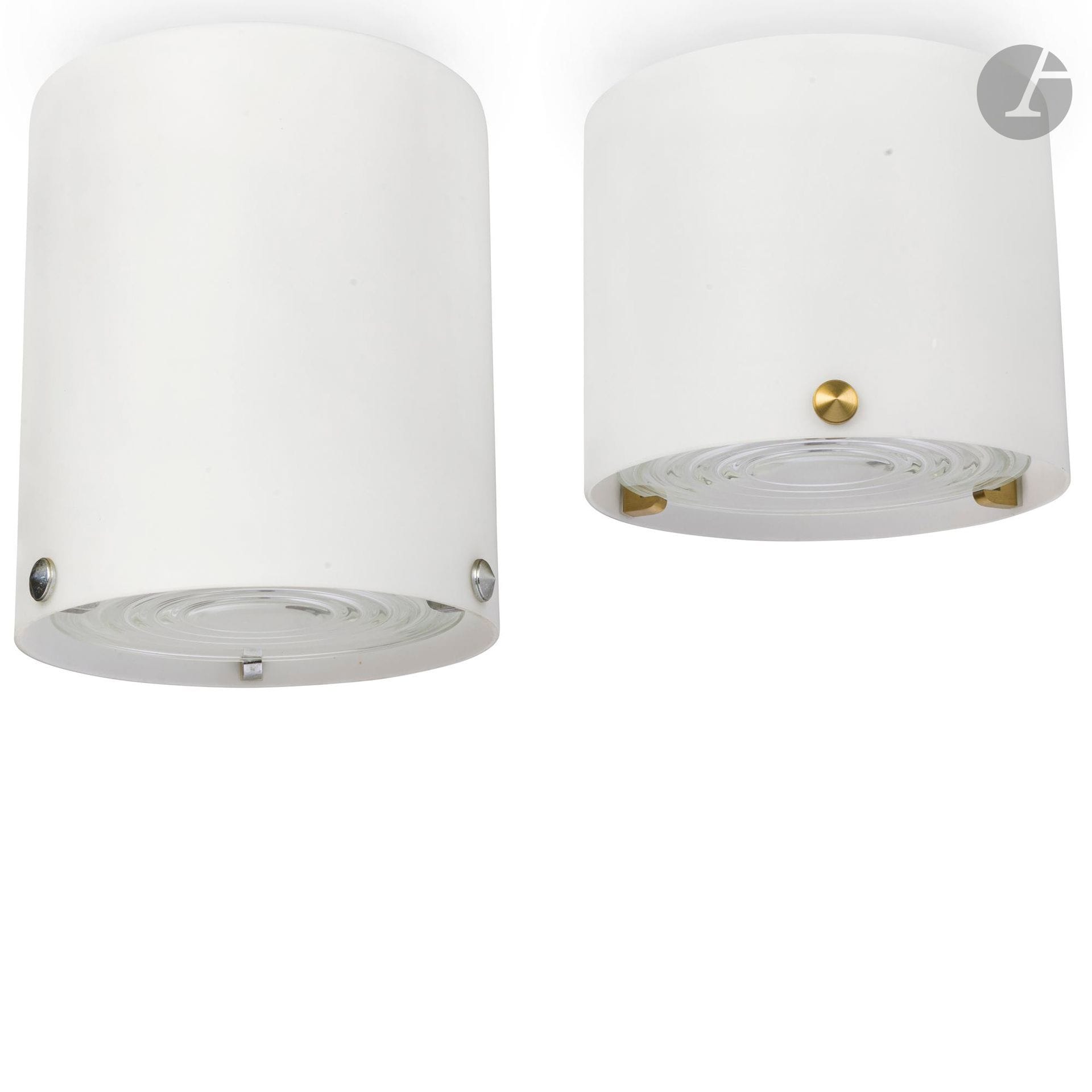 ATELIER JEAN PERZEL FOUNDED IN 1923 BY JEAN PERZEL (1892-1986) - 2 WORKS 
Model 2015A
Two cylindrical ceiling lights; two distinct heights. Prismatic disc supports in nickel-plated brass for the taller and in gilded brass for the other. Lined glass bulb covers. Each ceiling light complete with prismatic glass disc. H.26 cm and 19 cm