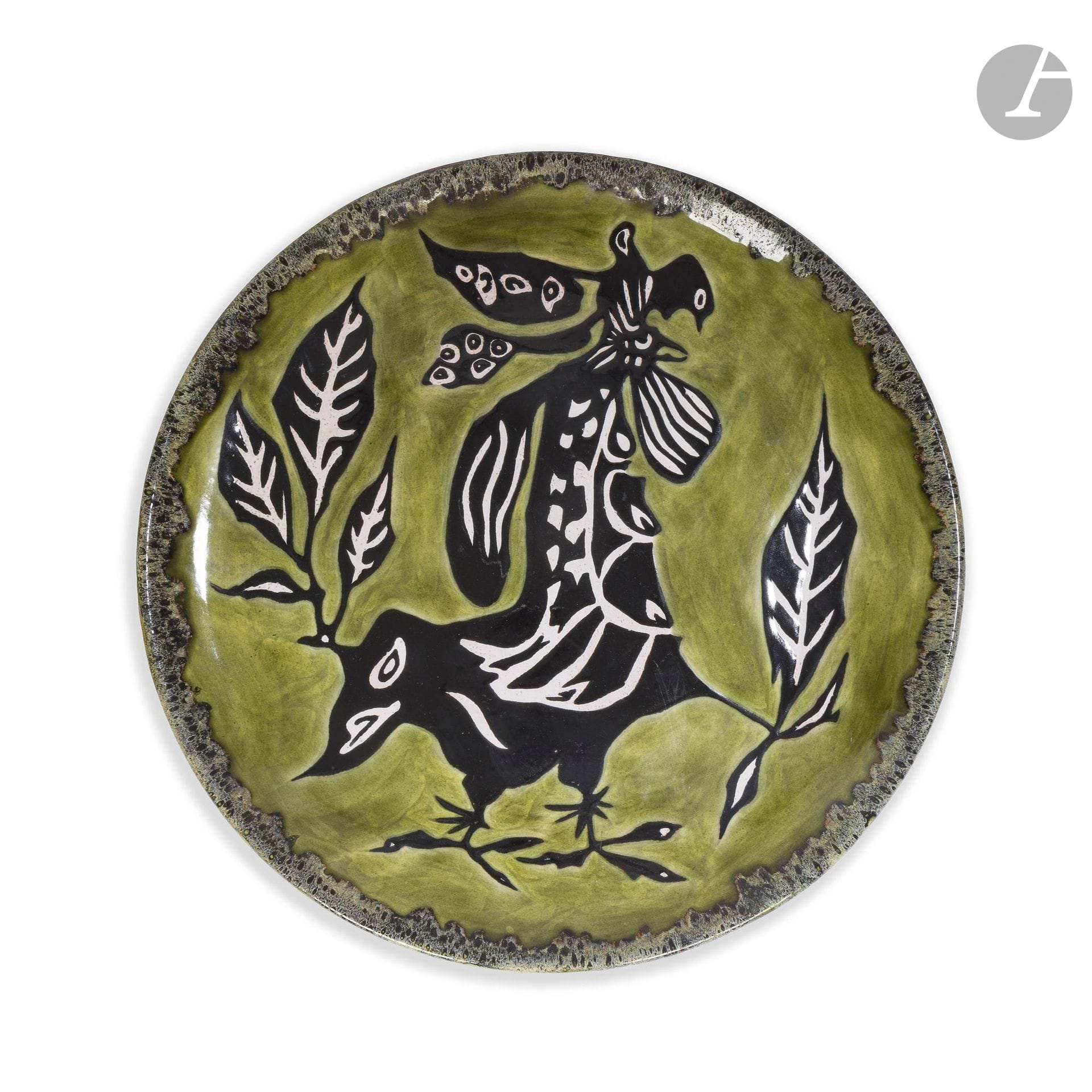 JEAN LURÇAT (1892-1966) PAINTER-CARTONNIER &amp; MANUFACTURE DE SANT-VICENS
Rooster and foliage, proof numbered 48/100
Large circular dish. Glazed ceramic proof; the title design is treated in black and white on a green background. Marked Dessin J. LURÇAT - Sant-Vicens - G.E. - and numbered 48/100 on the reverse. D.40,5 cm