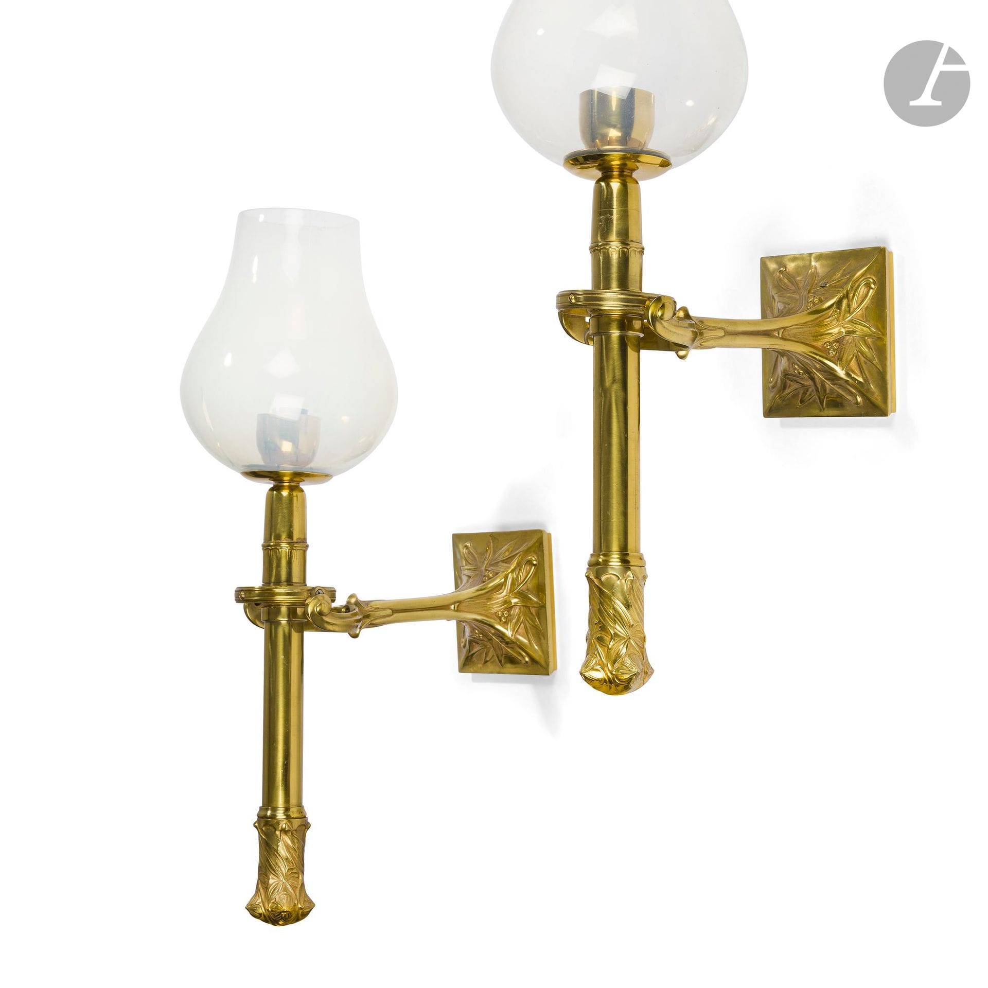 LUCIEN MAGNE (1849-1916) SCULPTOR &amp; EUGÈNE SOLEAU (1853-1929) PUBLISHER 
Stylized flowers
Pair of articulated torchère-style sconces. Gilded bronze and brass proofs. Art nouveau period. The opalescent glass bulb covers and electrification are not original.  Each sconce marked E. SOLEAU Paris on the plate. H.48 cm

Bibliography : 
- Art et Décoration - October 1903. Identical model, complete with shade holder and shade, reproduced on page 332.
- Alastair Duncan - The Paris Salons 1895-1914- Volume V: Objets d'art &amp; Metalware- Édition Antique Collectors' Club, 1998. Identical model, complete with shade holder and shade, reproduced on page 393.