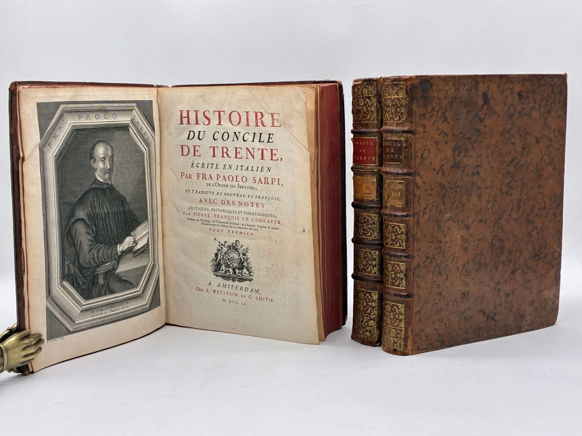 SARPI, Fra-Paolo and LE COURAYER, Pierre-François. History of the Council of Trent, written in Italian by Fra-Paolo Sarpi, of the Servite order; and retranslated into French with critical, historical and theological notes by Pierre-François le Courayer.
Published in Amsterdam by J. Wetstein and G. Smith in 1751.
In 3 volumes in-4, full tawny marbled calf, 5-rib spine, flowered boxes, gilt title and tomaison on red and beige morocco leather, red edges. Contemporary binding.
6 ff. (epistle), LXXII (preface) and 562 pp. ; 644 pp. ; 562 pp. 1 frontispiece by Sarpi engraved by F. Lucas. Engraved title vignette, bandeaux, lettrines and culs-de-lampe. Title printed in black and red.
Overall rubbed, with some loss to spine and spine ends, headpieces loose, 1 spine end restored, light scuffing to boards. Very rare and light foxing, rare annotations in red in the margins; clean inside nevertheless. 

French edition, translated from the Italian by Fra-Paolo Sarpi with critical, historical and theological notes, by Pierre-François le Courayer. 
First published without the author's authorization in London in 1619, the work was immediately translated into the main European languages, but soon placed on the index. The forbidden translations, which were immediately used by Protestants against the papacy, aroused the ire of the Church. The work, intended as an indictment of the Papacy and the Counter-Reformation, was a veritable indictment of the Council of Trent. It also earned Sarpi the reputation of being one of the best Italian historians after Machiavelli.
We present here the latest edition of Le Courrayer's translation, the most accomplished and the least committed. At the end of Volume III is a "Défense de la nouvelle traduction de l'Histoire du Concile de Trente, contre les censures de quelques Prélats et de quelques Théologiens" by Le Courrayer, on pages 249 to 474. 

A fine copy of this historical text, complete in 3 volumes.