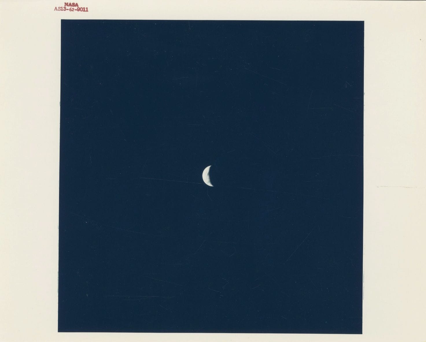 Apollo 13, April 11-17, 1970. 
Earth photographed from the command module during the return to Earth.
Vintage chromogenic print on "A Kodak Paper". NASA numbering in red AS13-62-9011 in the upper margin. NASA numbering stamped on verso. 
Image: 18.3 x 17.8 cm - Sheet: 20.2 x 25.3 cm