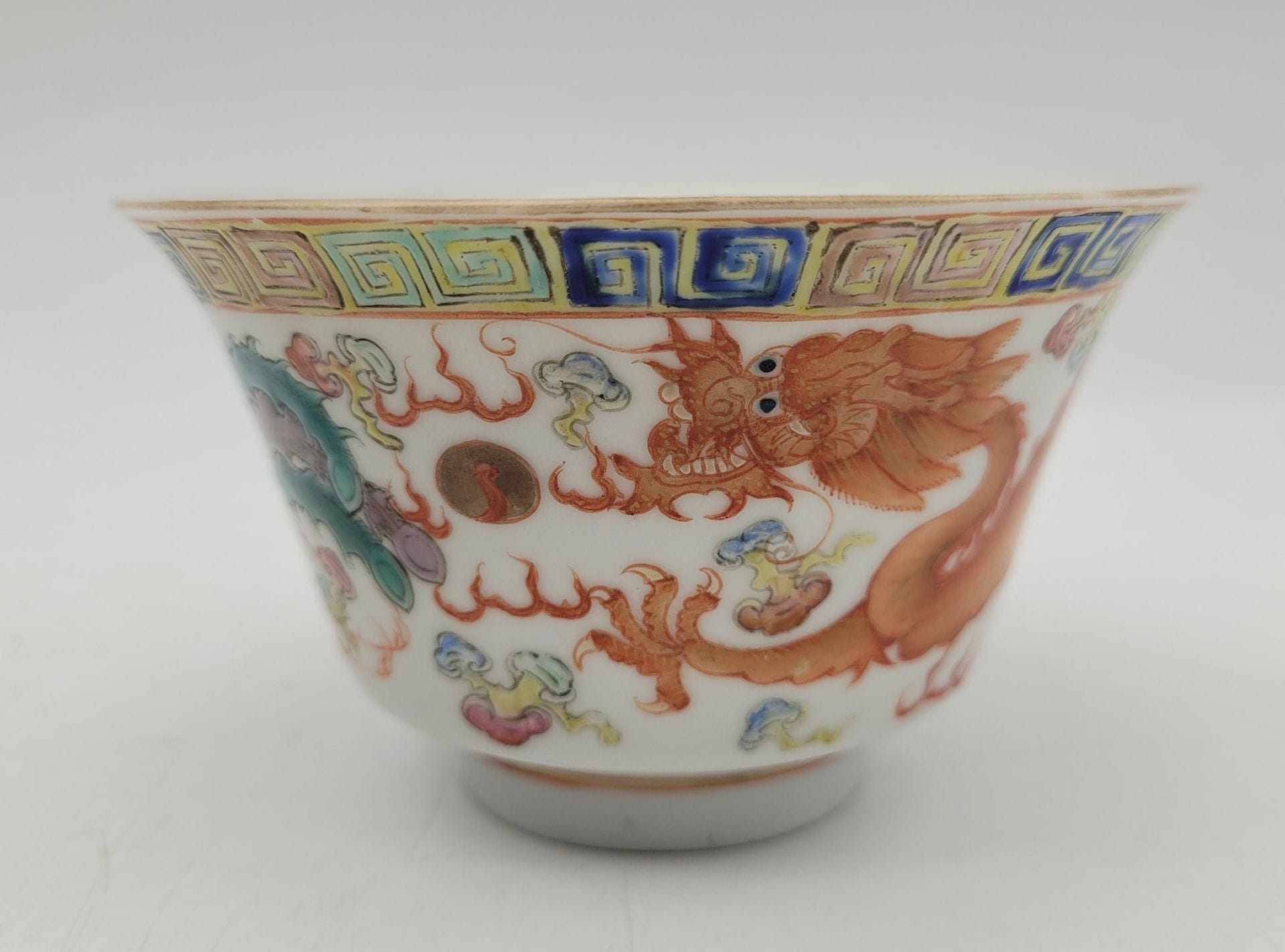 Small porcelain bowl, China, Guangxu period (1875-1908)
Polychrome decoration of a five-clawed dragon chasing a pearl, and a phoenix. Top edge adorned with a frieze of grecques. 
Six-character Guangxu mark in iron red under the base.
Height: 6 cm; diameter: 10.4 cm