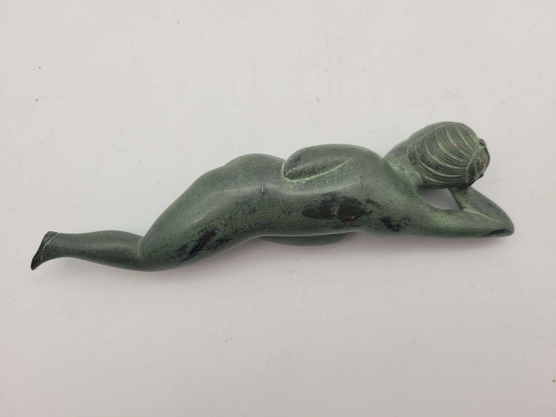 Sttauette en bronze à patine verte représentant une femme nue alanguie, Chine, XXe siècle 
Longueur : 16,7 cm