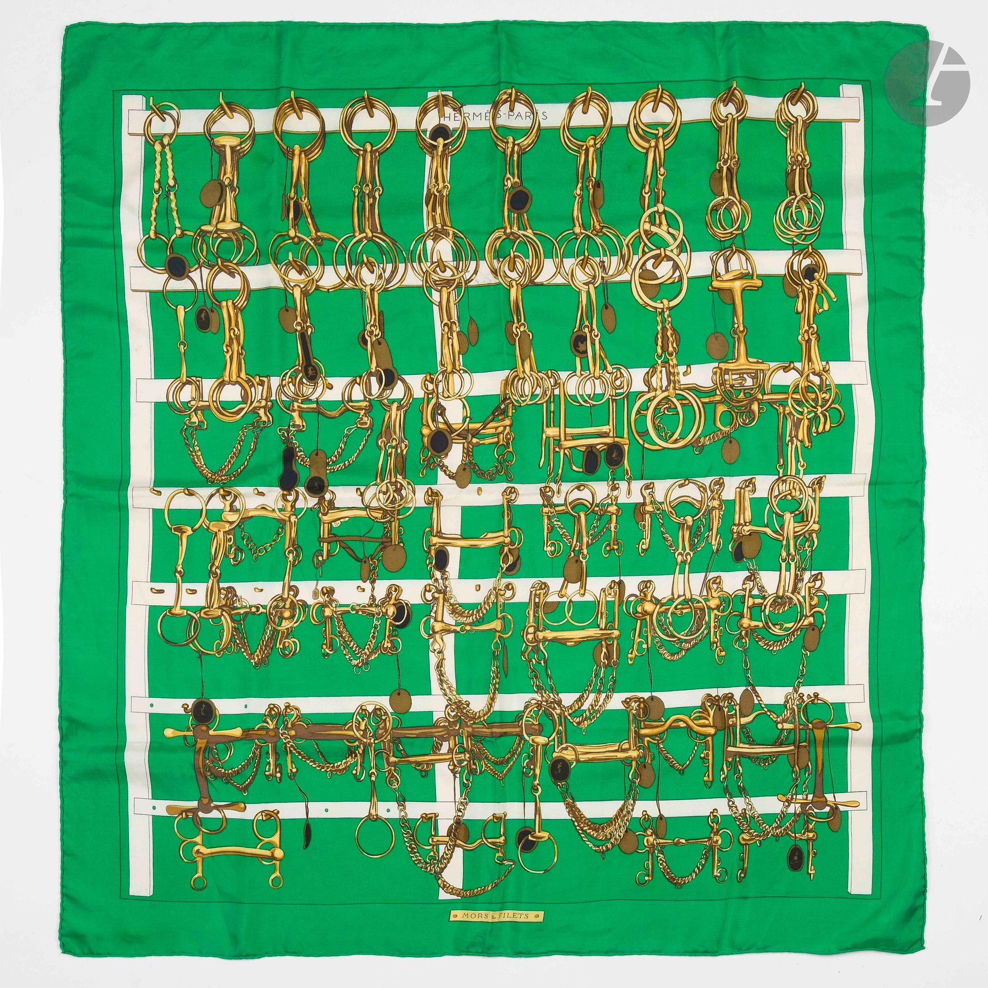 HERMÈS PARIS
Carré 90 in "Mors et Filets" silk twill, green background. In box
(stains, some discoloration and pulled threads)