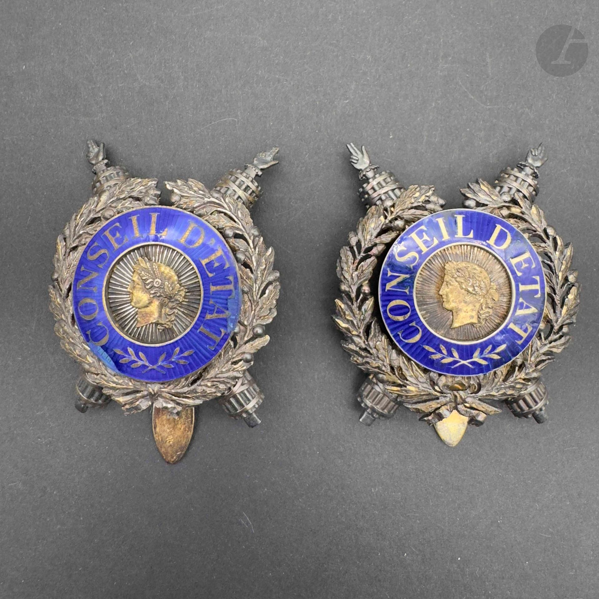 FRANCE 
COUNCIL OF STATE 
Two State Councilor badges in vermeil and enamel (chips restored), boar's head and Chobillon goldsmith hallmarks on one. 
Height: 44 mm - Total gross weight: 67 g