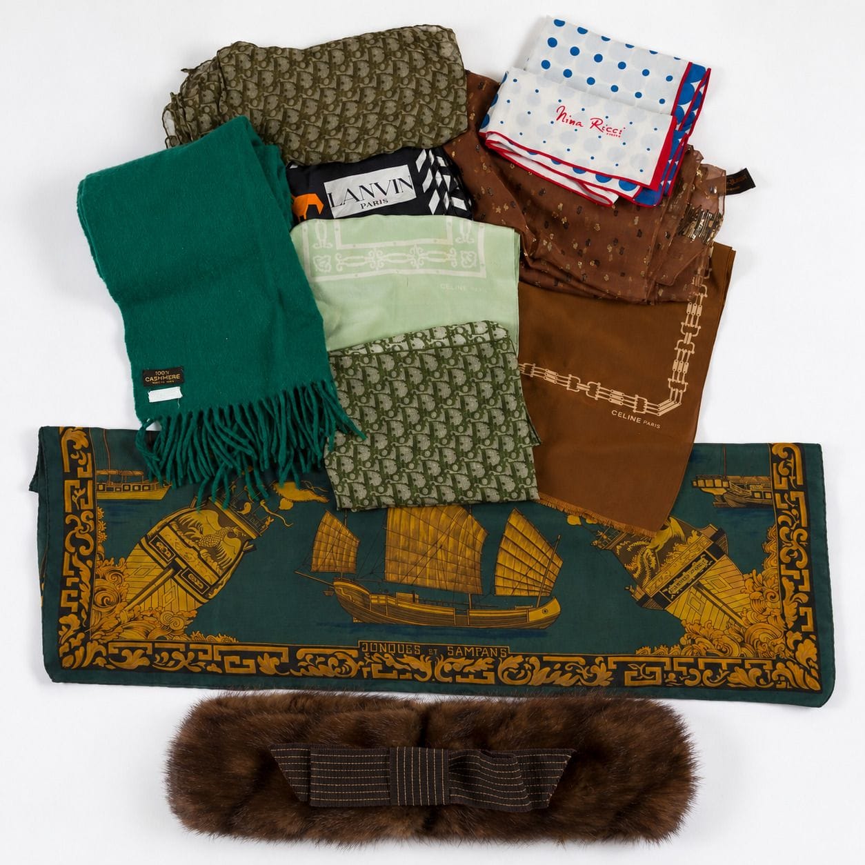 Set of 9 pieces, including 8 scarves: 
- a 90 HERMÈS square scarf titled "Jonques et Sampans" in shades of green (speckled)
- a green cashmere scarf by NINA RICCI. 183 x 43 cm (hole)
- a CHRISTIAN DIOR silk scarf featuring a green Oblique pattern on a beige background. 87 x 85 cm
- a CHRISTIAN DIOR muslin scarf featuring a khaki Oblique pattern on a cream background. 180 x 65 cm
- a LANVIN silk scarf. 77 x 77 cm
- a YVES SAINT LAURENT FOULARDS scarf in brown muslin with gold and black lamé. 153 x 54 cm
- a blue, white, and red NINA RICCI silk scarf
- a small CÉLINE scarf
- a CHRISTIAN DIOR mink headband (shows signs of wear)
