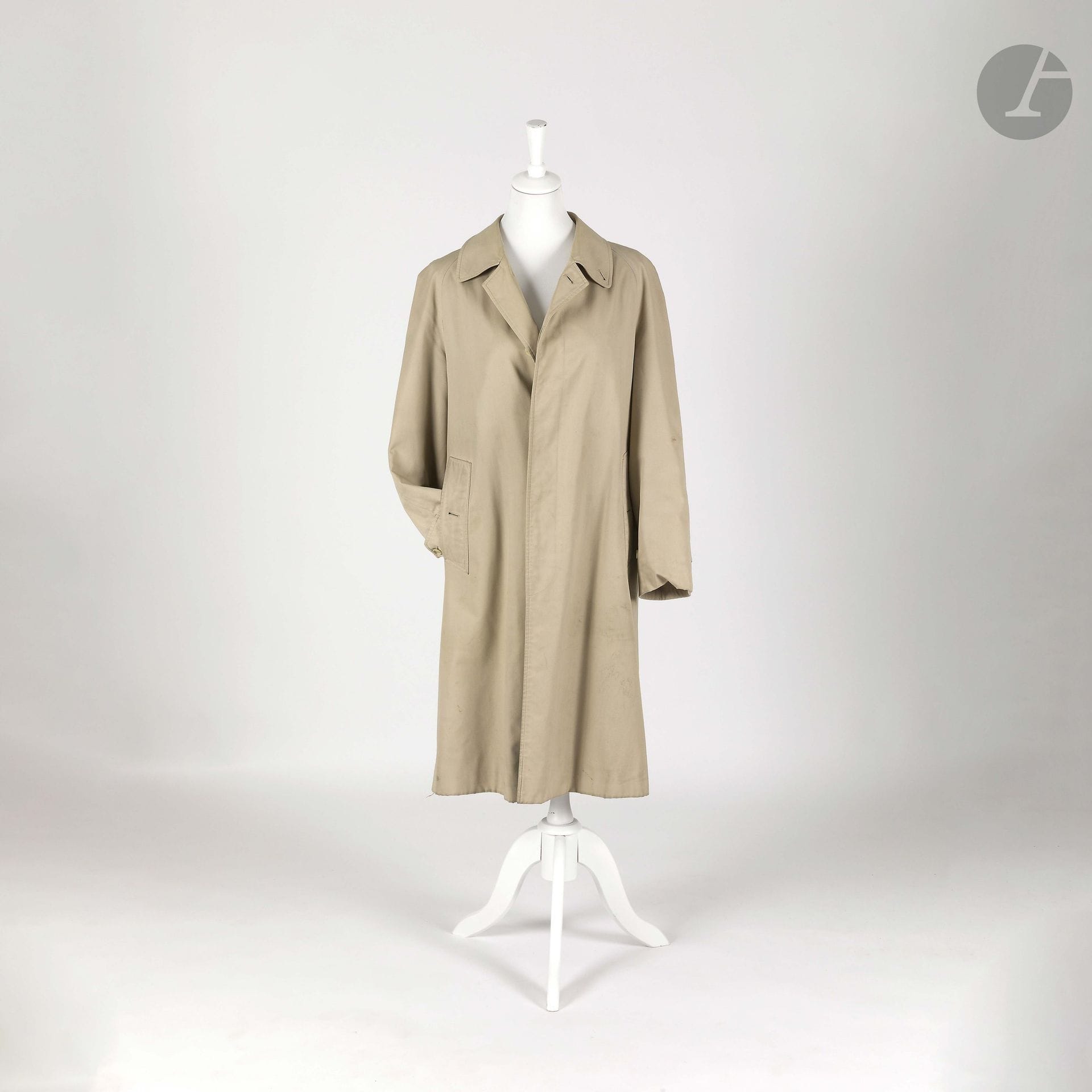 BURBERRYS'
Beige gabardine trench coat. Size 42 approx. (stains, some signs of wear)