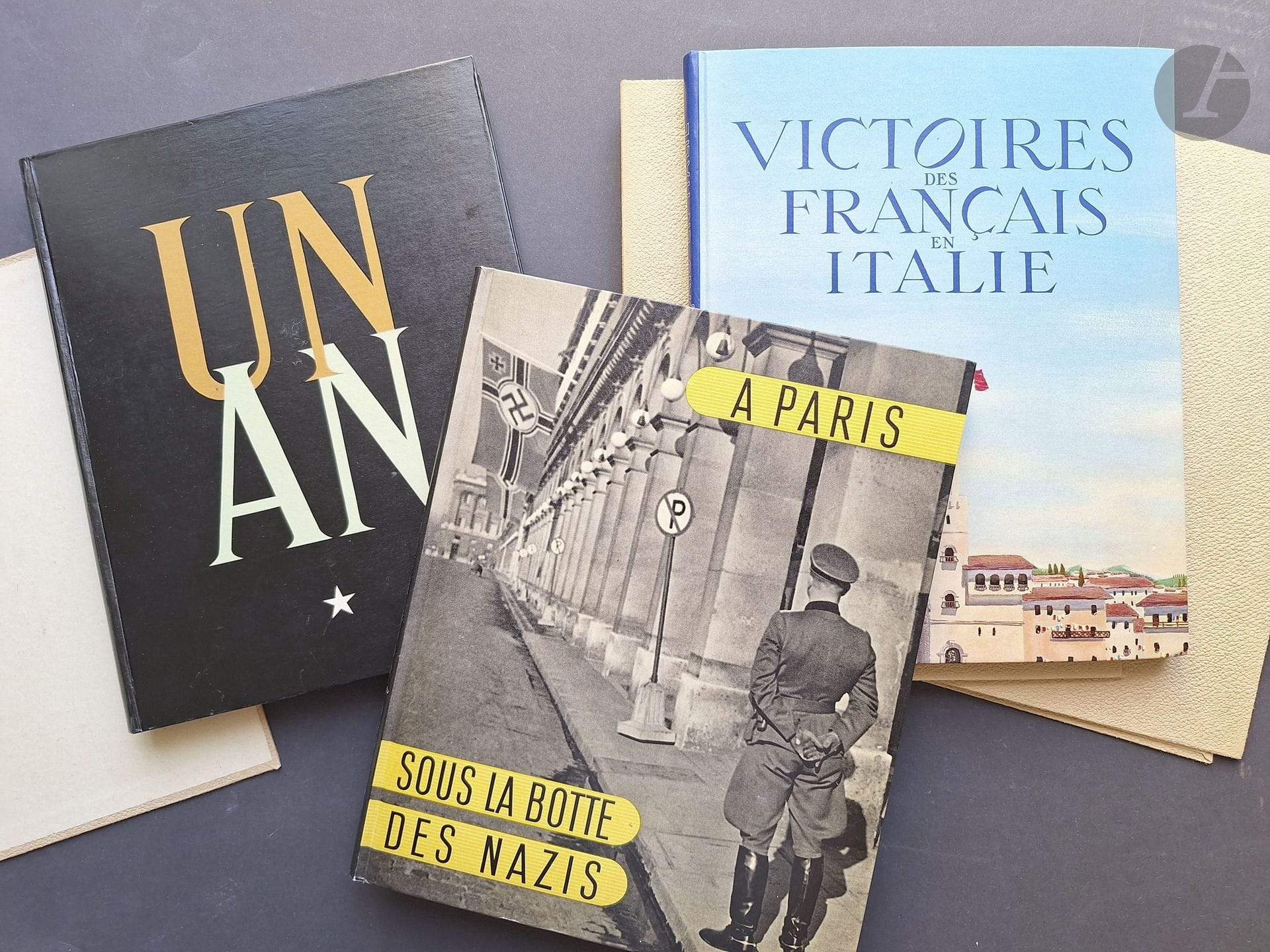 SCHALL, ROGER (1904–1995)
3 volumes, each in its own slipcase, with all three housed in the publisher’s slipcase.
*Paris Under the Nazi Boot, 1944.
*French Victories in Italy, 1946.
*One Year, 1946.
Raymond Schall Publications, 1944–1946.
3 in-4 volumes (27 x 21 cm). First editions. Black-and-white photographs reproduced by photogravure. Publisher’s bindings with illustrated covers. In slipcases and the publisher’s cream-colored slipcase.