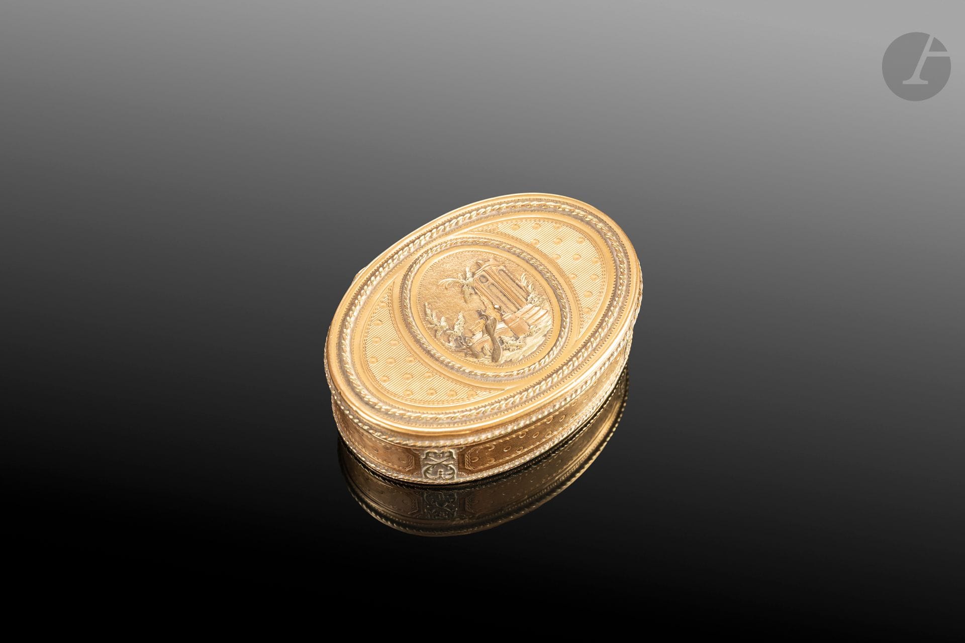 FRANCE 1784–1785
Oval-shaped snuff box in 750°/°° yellow gold with a hinged lid, the rim chiseled with four alternating panels of crossed palm leaves, featuring a classic Louis XVI-era design of medallions, striations, and twisted bands repeated on the lid, framing a central medallion depicting a scene of faux ruins and a peacock.
Master goldsmith: François-Nicolas CHEVANCE, admitted to the guild in 1780, apprenticed to the goldsmith Pointreau, one of whose snuffboxes is in the Louvre’s collections.
H.: 2.3 cm - L.: 7 cm - W.: 5.2 cm
Net weight: 71.3 g