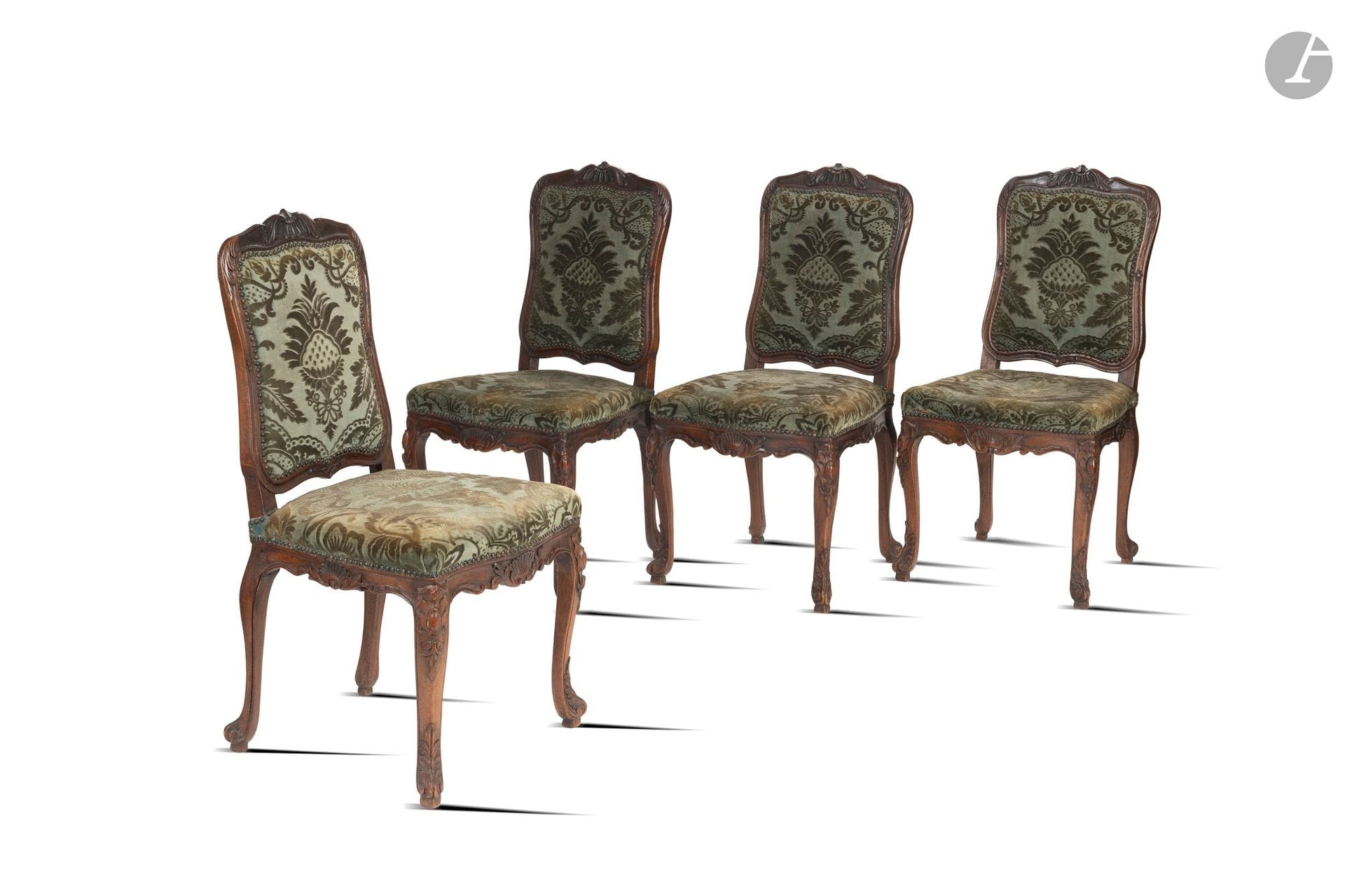 A set of eight Louis XV-style queen’s chairs in stained walnut, carved with shells and acanthus leaves, and resting on four curved legs. 
Upholstered in green velvet. 
Late 19th century. 
H: 102 cm - L: 42 cm - W: 48 cm
(Signs of wear and minor damage).

This lot comes from the reception hall of the Château d’Arcangues.