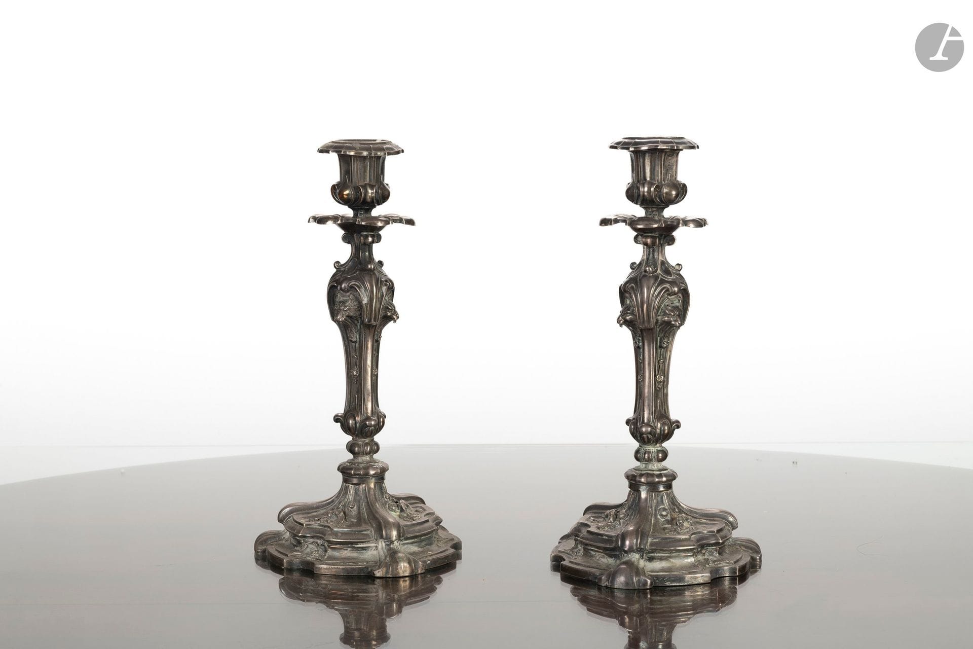 Pair of 925°/°° silver candlesticks. The shafts are decorated with lion heads.
Louis XV style.
France, 19th century. 
H.: 27 cm
Net weight: 1.03 kg

This lot comes from the reception hall of the Château d'Arcangues.