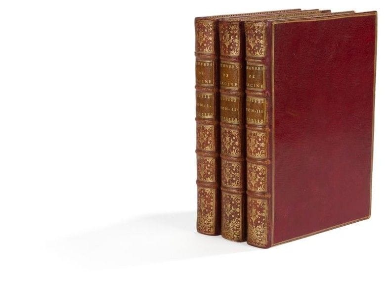 RACINE (Jean). Œuvres. Paris, 1760. — 3 volumes in- 4, (2  ff.), xviij  pp. , (3  ff.), 414  pp. , 1 portrait, 5 planches ; (2  ff.), iv, 447  pp. , 5 planches ; (2  ff.), iv, 412  pp. , 2 planches. Maroquin rouge, triple filet doré en encadrement sur les plats, dos à nerfs orné, roulette dorée intérieure, tranches dorées (reliure de l’époque).

L’une des plus belles et des plus luxueuses éditions des œuvres de Jean Racine.
Elle est illustrée en premier tirage d’un portrait de l’auteur gravé par J. Daullé, de 3 vignettes de titre, 13 en-têtes, 
60 culs-de-lampe et 12 planches, gravés par Chevillet, Baquoy, Legrand, Flipart, Tardieu, Le Mire, Aliamet, Lempereur, Sornique d’après les compositions de Jacques de Seve.
Bel exemplaire en maroquin rouge de l’époque.
Dos légèrement passés, quelques craquelures aux charnières, habiles restaurations aux coiffes et aux charnières, petit manque à un coin. Quelques feuillets roussis, comme souvent. Dans le premier volume, le cul-de-lampe de la page 299 a été reproduit à l’envers.
Provenance : de la bibliothèque du bénédictin Andrea Mazza (1724-1797), frère du poète Angelo Mazza, avec cette note manuscrite sur le premier titre : “Ad usum D. Andreae Mazza Ab. C. dom. B.”.