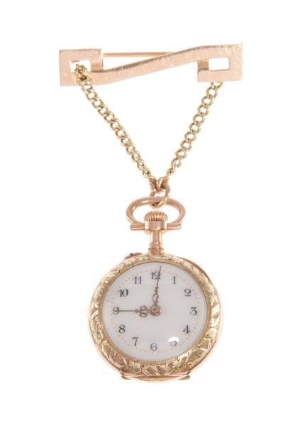 Montre de poche en or jaune, retenue par une broche en or jaune. Poids brut: 21 g