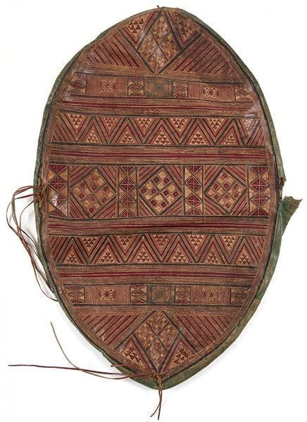 Deux coussins ornementaux touaregs en cuir, Sud Sahara, ou Niger, début XXe siècle Un oblong et l?autre circulaire, en cuir brun, ocre, noir et grenat, à décor incisé ou peint de motifs géométriques, agrémentés de lanière sur les côtés. Dim.: 40 x 61,5 cm; 55,5 cm état: Sur l?un, un côté déchiré


Two leather Touareg cushions, Sub-Saharan Africa, or Nigeria, 20th century