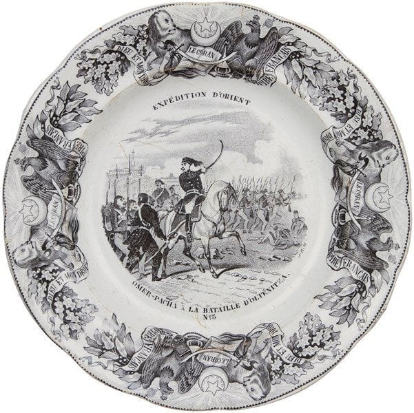 Faïence de Gien, France, datée 1844, assiettes de la série «Expédition d?Orient» Sept assiettes à dessert à décor orientaliste, toutes titrées avec une scène au centre et un marli au décor d?aigles royaux et lions, séparés par un coran, un sabre militaire, un narghilé, l?étoile et le croissant musulman ainsi que d?une banderole où est inscrit: «Dieu et mon droit, empire français». Au revers, marque de la maison où est inscrit: «médaille exposition 1844, porcelaine opaque. Gien, Geoffroy et Co». Diam.: 20 cm État: légers éclats. 


A serie of seven porcelain painted plates on the «Expedition of Orient», France, dated 1844