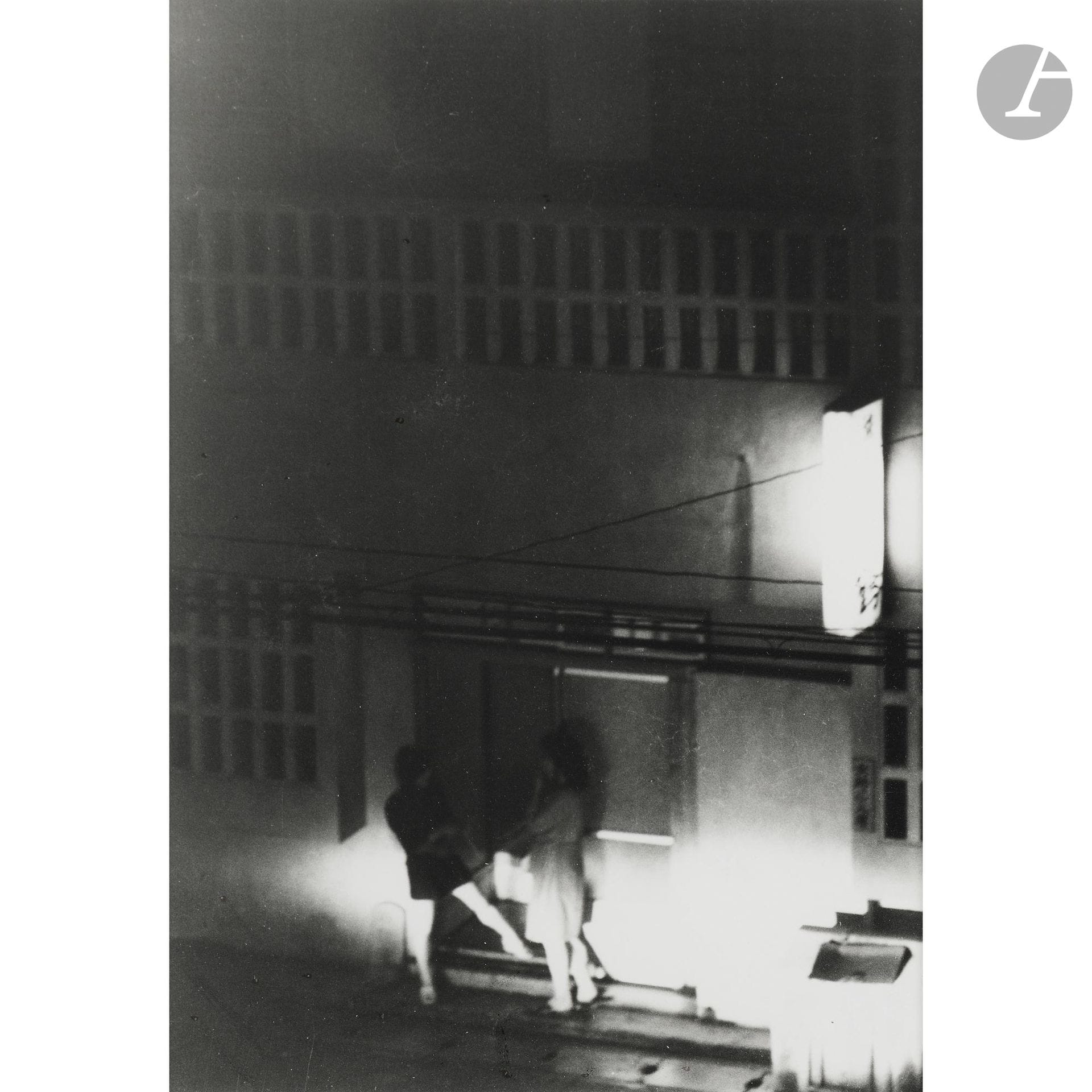 Kenshichi Heshiki (1948–2009) 
Sakae-machi, de la série Women who saved Okinawa. Naha, 1972. 
Épreuve argentique d’époque, signée, titrée, datée et annotée au crayon au verso. Sceau sur étiquette contrecollée dans la marge en bas à droite. Étiquette de la Nap Gallery au verso du cadre. Un certificat d’authenticité de la Nap Gallery accompagne l’œuvre.
Image : 19 x 13,3 cm - Feuille : 25,6 x 20,5 cm - cadre

Provenance : 
Nap Gallery, Tokyo.

Cette épreuve a fait partie de la sélection de Karl Lagerfeld lors de l’édition 2017 du salon Paris Photo.