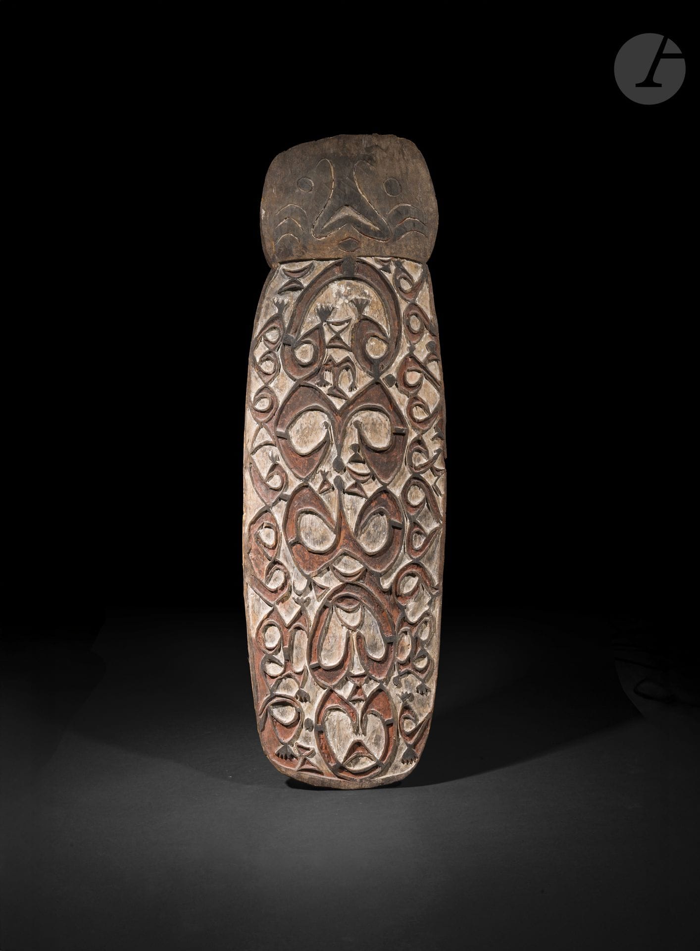 Bouclier, Asmat, Papouasie occidentale, Papouasie-Nouvelle-Guinée
Hauteur : 128 cm
Bois et pigments.
La profonde patine d’usage et l’archaïsme de sa sculpture confèrent à ce bouclier un caractère d’une remarquable ancienneté. Les volumes puissants, le modelé vigoureux et l’absence de recherche ornementale superflue traduisent une œuvre où l’expressivité naît avant tout de la force de la taille. Ce bel exemplaire illustre les qualités des premières productions asmat, aujourd’hui particulièrement recherchées pour leur authenticité et leur remarquable présence sculpturale.

Provenance : 
John Giltsoff, Bruxelles.