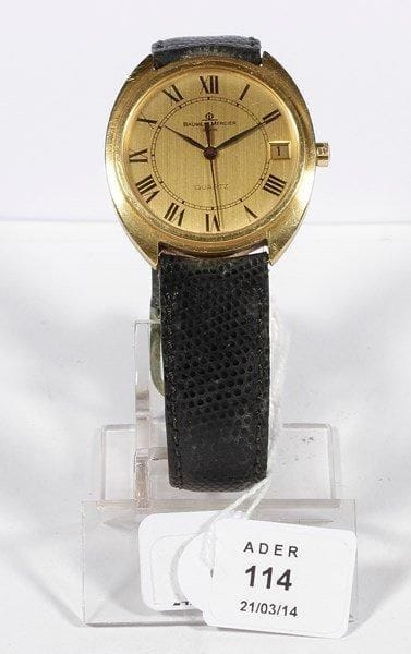 BAUME MERCIER
Montre bracelet d'homme ronde en or, à quartz, chiffres romains. Trotteuse centrale et date à 3H. Bracelet en cuir.. Poids brut: 49 g