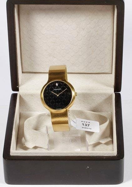LONGINES
Montre bracelet d'homme en or. Cadran fond noir à décor de sérigraphie. Bracelet souple en or. Remontage manuel, glace minérale. Numérotée 17706350.. Poids brut: 80 g. Bon état.. Ecrin en bois à 4 vices