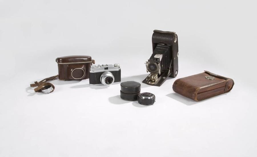Appareil photographique Foca Sport, corps métal aspect satiné et gainé cuir. Objectif Foca neoplar 4,5 cm f/2,8. Avec sa sacoche cuir. On joint un objectif supplémentaire Komura Sankyo. C. 1940. On joint: Appareil photographique à soufflet, modèle D, Eastman Kodak. Film bobine, corps métal gainé cuir granité, avec sa sacoche cuir. C. 1940