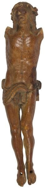 Christ en ivoire sculpté, patine brune, tête levée vers le ciel, couronne d'épines, mèches ondulées tombant sur les épaules, périzonium retenu par une cordelette. XVIIe siècle Hauteur: 23,5 cm (Manque les bras, accidents aux pieds, à la couronne d'épines)