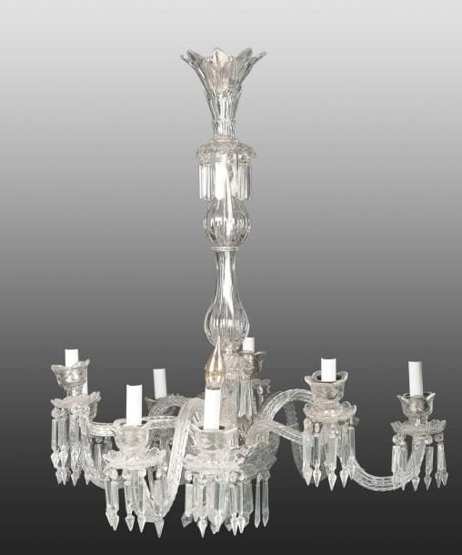 Lustre Baccarat à neuf bras de lumière, France pour l'Orient, XXe siècle Luminaire à neuf branches de verre, torsadées à coupelles et pampilles. Corps formé de deux parties piriformes se terminant par une coupelle inversée à pampilles et attache évasée. H.: 97 cm; Diam.: 80 cm Etat: pampilles manquantes A Baccarat chandelier, France, 20th century