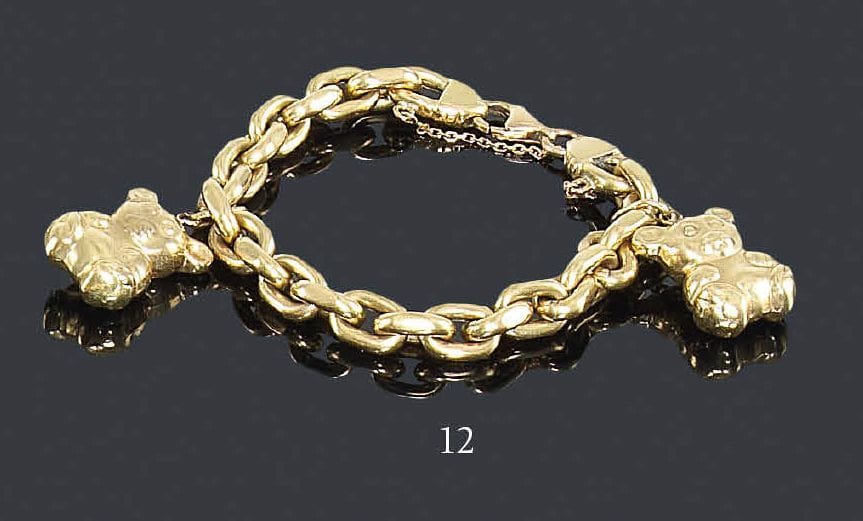 Bracelet en or jaune 18K, maillons gourmette, retenant deux oursons en or 18K en pampilles. Longueur: 18,5 cm - Poids: 26,3 g