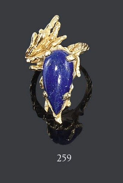 CHAUMET
Bague en or jaune «sauvage» asymétrique, sertie d'un lapis lazuli cabochon. Signée, commande spéciale. Travail des années 1970. Tour de doigt: 56/57 - Poids brut: 16,8 g