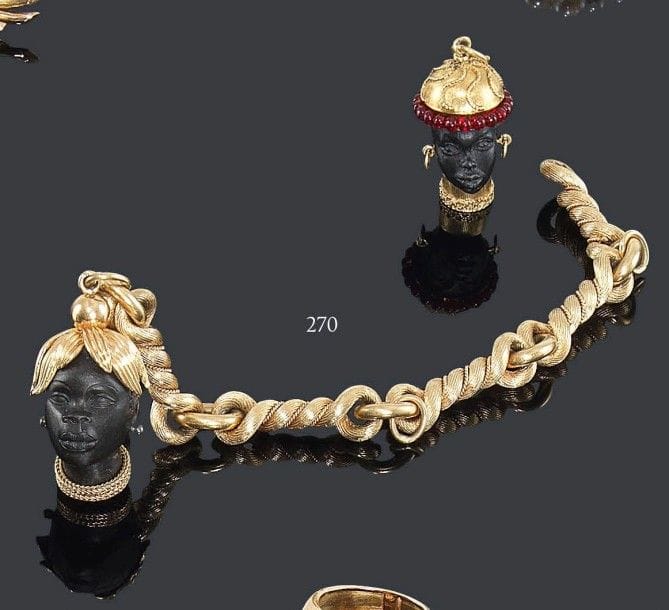 HERMES
Bracelet en or 18K, torsades réunies par des anneaux, retenant en pampille une tête de Maure en bois précieux sculpté, la coiffe et le collier en or. Le bracelet signé et numéroté 53346. Longueur: 20 cm - Poids brut: 93,3 g On joint une pampille Maure supplémentaire Poids brut: 9,6 g (colle)
