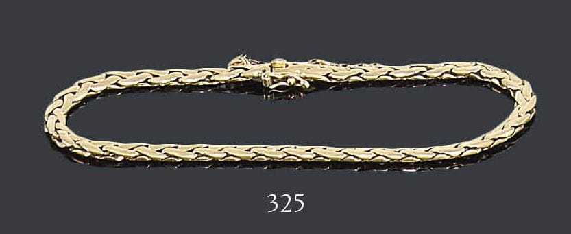 CARTIER
Bracelet en or jaune 18K, petits maillons plats. Signé et numéroté 229205. Longueur: 19,8 cm - Poids: 13,7 g
