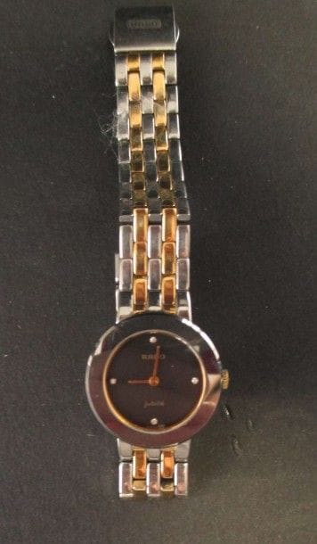 RADO
Montre de dame en acier, cadran rond, fond noir, index piqué de 4 diamants, bracelet articulé, mouvement quartz. Signée et numérotée 38051828.