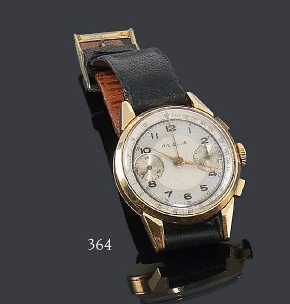 REGLIA
Montre chronomètre en or 18K, années 50, joli cadran en bon état, chiffres arabes, beau mécanisme roue à colonnes (calibre valjoux 22). Bracelet en cuir. Poids brut: 53 g
