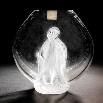 MAISON LALIQUE d'après un modèle de Marie-Claude LALIQUE (1935-2003)
Garance, modèle créé en 1983 Vase en cristal moulé-pressé et, en partie, satiné. Vendu dans son coffret d'origine. Signé LALIQUE ® France en lettres cursives, à la pointe, sous la base. H.: 22,5 cm