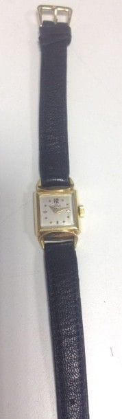 OMEGA
Montre de dame en or jaune 18K (750 ?), cadran carré, fond satiné, mouvement mécanique, bracelet en cuir à boucle ardillon en métal doré. Signée et numérotée. 
Poids brut: 12,3 g