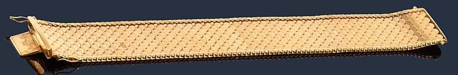 Bracelet ruban souple en or jaune 18K (750‰), à motifs d’écailles imbriquées. 
Dimensions : 20 x 2,5 cm environ. Poids : 69,2 g