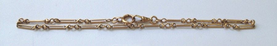 Chaîne giletière en or 18K (750‰), maille fantaisie. 
Poids : 16,3 g