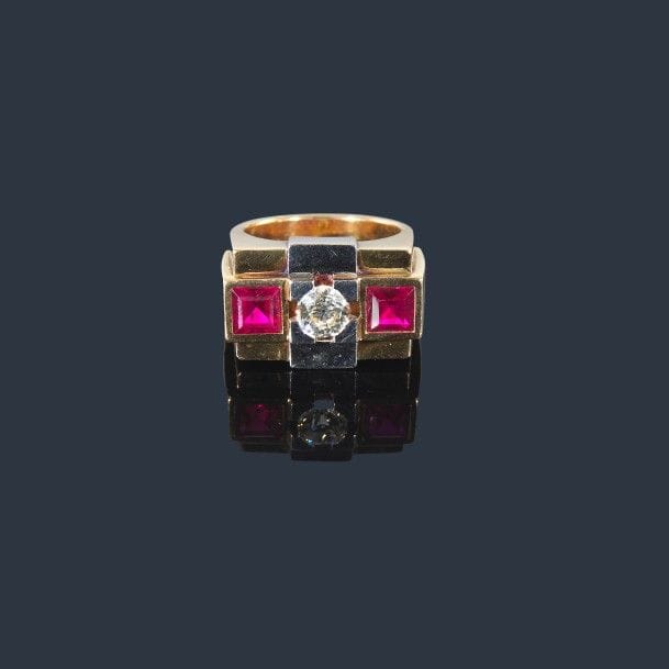 Bague en or jaune 18K (750‰) et bandeau de platine, ornée d’un diamant de taille ancienne entre deux pierres synthétiques de couleur rouge. Travail des années 1940. Tour de doigt : 54/55. Poids brut : 15,3 g
(égrisures)