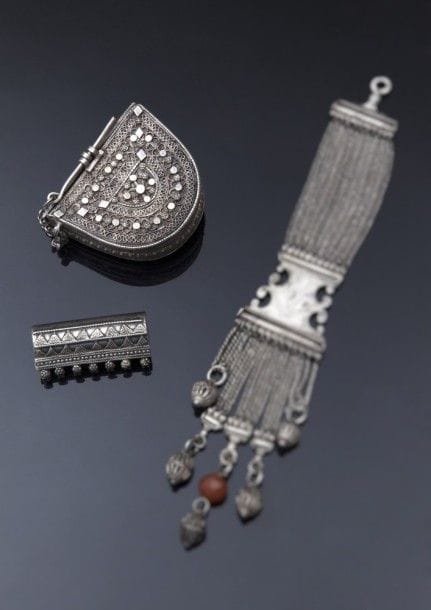 Boîte talismanique et pendant en argent, Yémen, Hadhramaut, XXe siècle
Boîte semi-cylindrique à décor filigrané et appliqué de motifs géométriques en registres ;-le pendentif cylindrique à décor de deux registres de triangles en points.
Dim. : 6,6 x 8,2 cm ; 6 x 2,8 cm 
P. : 190, 46 g.
Pour un autre exemple de pendant, voir S. Wolf-Dieter, Jewellery from the Orient: Treasures from the Dr. Bir Collection, Stuttgart, 2009, p. 139, n° 346. 
A silver box and a pendant, Yemen, Hadharmaut, 20th century