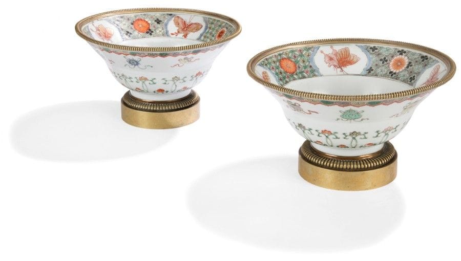 CHINE - Époque KANGXI (1662 - 1722)
Paire de bols en porcelaine décorée en émaux polychromes de la famille verte des huit emblèmes bouddhiques « bajixiang » et de fleurs, à l’intérieur quatre papillons en réserve sur fond de treillis fleuris. 
(Fêlures, restaurations, montures en bronze doré). 
Diamètre : 21 cm