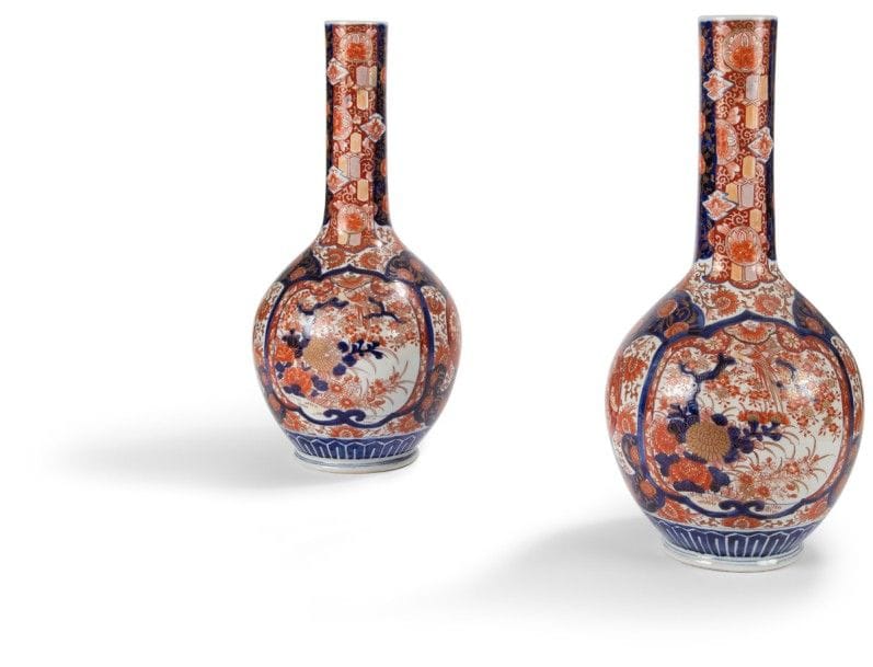 JAPON - Époque MEIJI (1868 - 1912) 
Paire de vases bouteilles en porcelaine blanche décorée en bleu sous couverte, rouge de fer et émail or de médaillons d’oiseaux et fleurs. 
Hauteur : 51 cm
