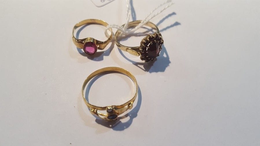 Lot de 3 bagues en or jaune 750 °/°° ornés de grenats et pierres bleues. Poids brut : 5,3 g
