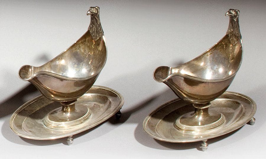 Paire de saucières ovales posant sur un présentoir à 4 pieds boules, décoré de filets, la prise gravée à décor de tête d'aigle. 1809-1819. Poids brut : 1,590 kg
