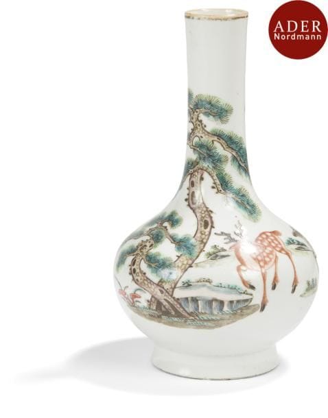 CHINE - Époque JIAQING (1796 - 1820)
Vase bouteille en porcelaine décorée en émaux polychromes d’un couple de daims sous les pins survolés par une grue. (Égrenure au talon). 
Hauteur : 21,5 cm