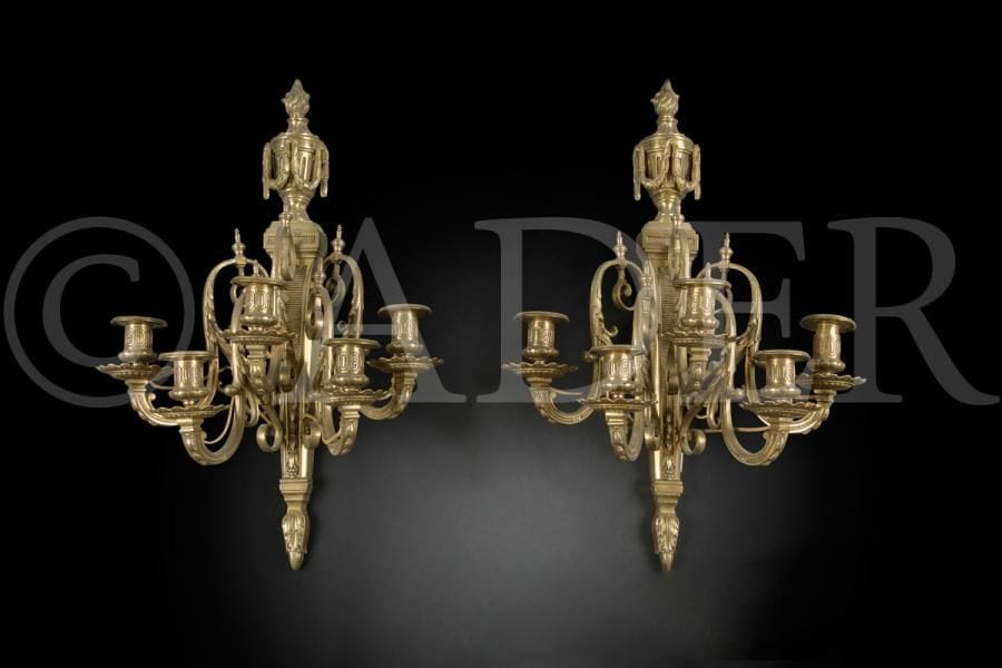 Paire de grandes appliques en bronze verni à cinq lumières en enroulement feuillagé, surmonté d’un vase à guirlandes ; (percé pour l’électricité).
Style Louis XVI.
H : 60 cm