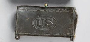 Boite cartouchière US. En cuir noir frappé « US ». Attache en laiton.  1870-1880