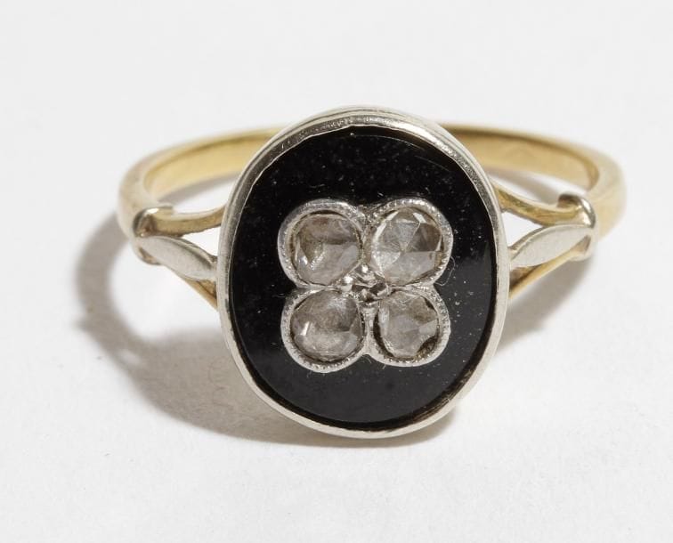 Bague en or 18 K (750) ornée d'onyx et roses.
Poids brut : 3 g