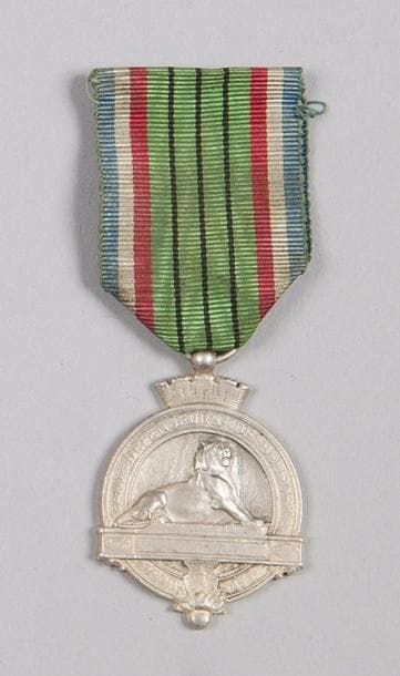 FRANCE 
Médaille des défenseurs de Belfort (1870-1871). 
En métal argenté. Ruban ancien. 
Hauteur : 4 cm
SUP.