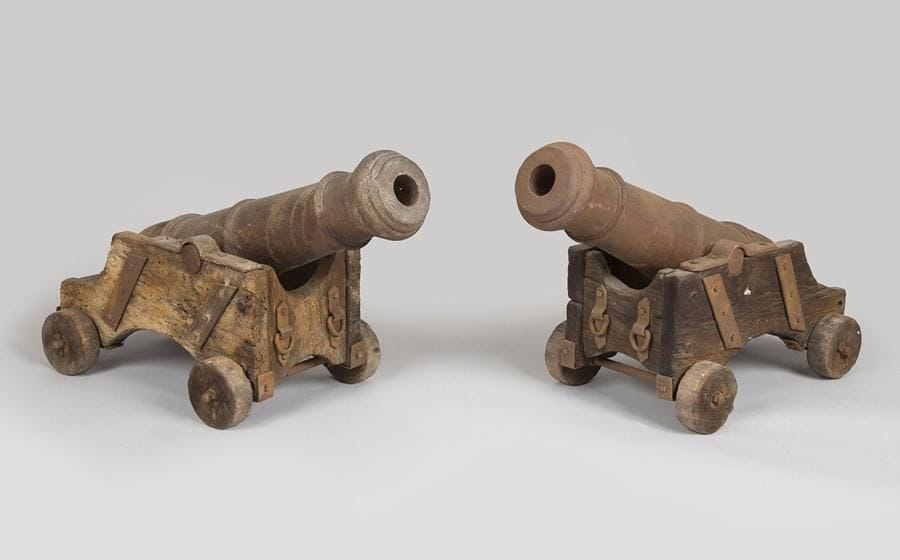 Deux canons de port. 
En fonte de fer, à deux tourillons et 5 anneaux de renfort. 
Affûts de marine en bois à garnitures en fer et quatre roues pleines. 
Hauteur : 27 cm 
Longueur fût : 56 cm - Longueur totale : 60 cm