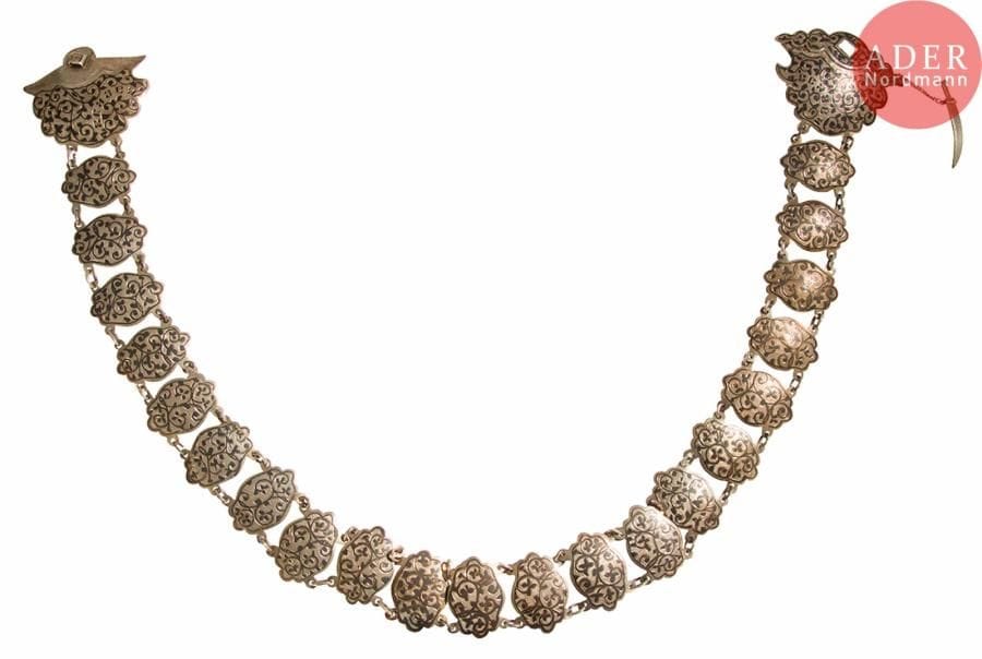 Ceinture caucasienne en argent 84 zolotniks (875 millièmes) à maillons et boucle fermée par un kindjal miniature retenu par une chaînette, à décor niellé de rinceaux feuillagés sur fond guilloché et de l’inscription en russe Caucase. Bon état, légères usures.
Russie, probablement Kiev, 1899-1908.
Orfèvre : MM, non repertorié.
Poids brut total : 137,9 g. L. 70 cm

