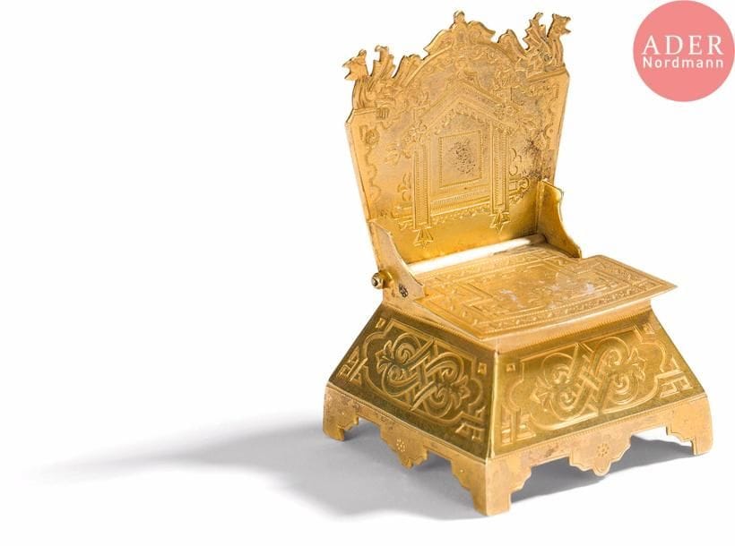 Salière en vermeil 84 zolotniks (875 millièmes) en forme de chaise s’ouvrant à charnière, à décor ciselé d’entrelacs et motifs russes traditionnels. Bon état.
Moscou, 1889.
Orfèvre : ICA en cyrillique, non repertorié.
Poids : 48,41 g. H. 6,5 x L. 4,5 cm

